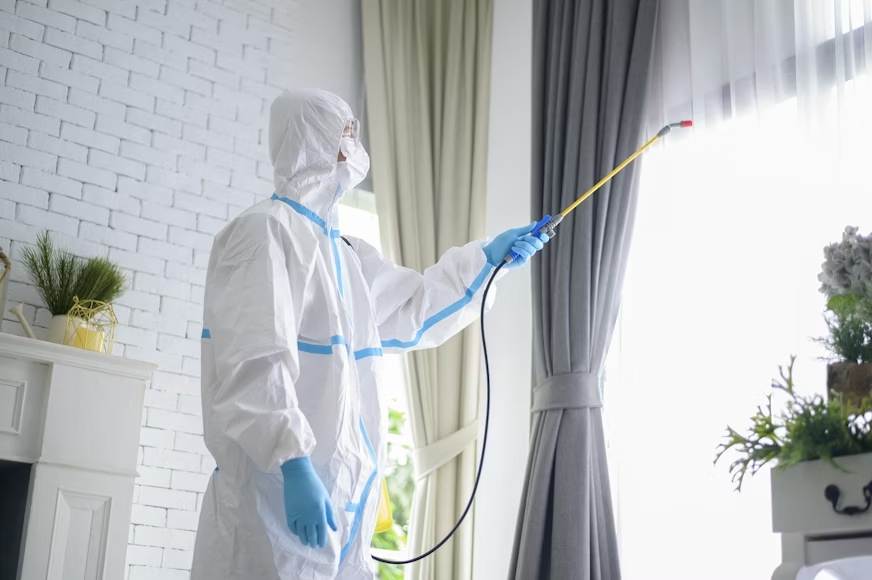 Certified pest control professional applying treatment